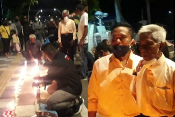 Anggota DPRD kota Kupang, Jeftha Van Sooai saat menyalakan lilin serta Saul Manafe, ayah almarhumah Astrid dilokasi seribu lilin (yandry/kupangterkini.com)